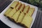 Bika Ambon, Indonesian cake with square slices in white plate. Yellow cake from Medan, Indonesia