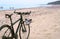 Bike on the beach, sneakers hanging on the bike, sea and bike