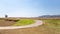 Bike or bicycle with pink or violet poppies flower field and green lawn on hill and mountain and blue sky.