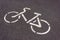 Bike Lane. White painted symbol on asphalt in a park