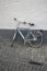 Bike leaned against on a dark grey and white wall