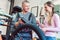 Bike Mechanic and customer looking at the bicycle that needs service