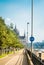 Bike path at the Danube embankment at the center of Budapest and signs, and Parliament building at the background, Hungary.