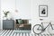 Bike and poster on the wall in a modern living room interior wit