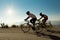 Bike race in uphill road bikers shandows sun