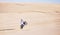 Bike, sand and fitness with a man in the desert for adrenaline, adventure or training in nature. Motorcycle, speed and