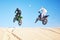 Bike, sand and sports with people in the desert for adrenaline, adventure or training in nature.