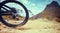 Bike, sport and adventure with a bicycle wheel in the dirt for adventure, risk or freedom and a mountain in the