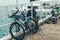 Bike stands on a pier against the background of a sailing yacht on azure sea water