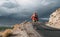 Bike tourist rides on Himalaya mountain road on way to buddist m