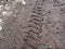 Bike, tractor, excavator, car, automotive tire tracks on muddy trail. Mud and wheel trace on road after rain.