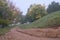 Bike trail with yellow and rusty autumn trees, in a city park - Alexandru Ioan Cuza park IOR, Bucharest, Romania.