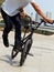 Bike, trick and closeup of man outdoor for sports, balance and action at urban skatepark. Male person, bicycle stunt and