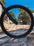 Bike Wheel. Mountain, ramp, trees and sky.