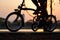 Bike wheels close up image on asphalt sunset road