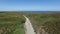 Biker biking on a dirt road to the ocean