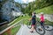 Biker couple looking at Predjama Castle inside Postojna cave in Slovenia