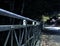 A Biker Crosses a Bridge in the Nighttime