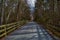 Biker Crosses Crushed Stone Path Bridge at Henlopen State Park`s Junction