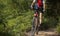 Biker cycling on summer forest trail