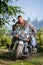 Biker driving his cruiser motorcycle on road in the forest