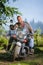 Biker driving his cruiser motorcycle on road in the forest