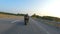 Biker is driving motorbike during road trip at autumn sunset time. Man ride fast on modern sport motorcycle at highway