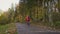 Biker on an empty autumn forest road