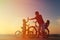Biker family silhouette, father with two kids on