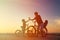 Biker family silhouette, father with two kids on