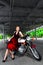 Biker girl in dress on a motorcycle over the