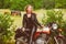 Biker girl in leather jacket on a motorcycle over