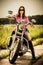 Biker girl sitting on motorcycle