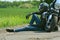 Biker and his favorite motorcycle. Motorcyclist rests near the motorbike