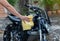 Biker man cleaning motorcycle , Polished on fuel tank
