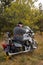biker in medieval knight\'s armor sits on a motorcycle against the background of the forest