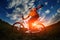 Biker in orange jersey riding on green summer field