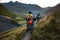 Biker pushes his bicycle up in high Caucasus mountains