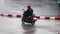 A biker ride on a motorcycle at wet street during a heavy rain