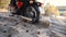 Biker rides on a sandy road in the forest