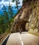 Biker riding into mountainous tunnel