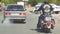 Biker on the road in the city among cars