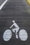 Biker silhouette painted in white on a wooden cycle path, Arcachon, France