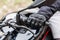 Biker sitting on motorcycle, close-up view on hands on handlebar