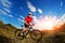 Biker tourist travel on mountain bike. Autumn landscape. Sportsman on bicycle in red jersey and white helmet