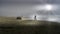 Bikers in Dense Fog biking on the Beach in Cox Bay at the Pacific Rim National Park