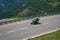 Bikers in mountain road in action ride, traveling across Europe, motorcycle tour, curve highway in mountains, copy space, extreme