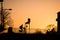 bikers passing on bridge silhouette by sunset