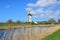 Bikers passing by an old windmill in Damme