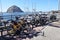 Bikes against a metal railing at Morro Bay Ca. with the Rock in the distance on a sunny day